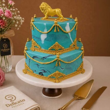 A Luxurious Two-tiered Cake Made Of Teal Marble And Gold Tassels.